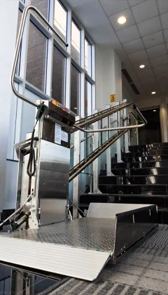 An inclined platform lift installed in an indoor commercial building.