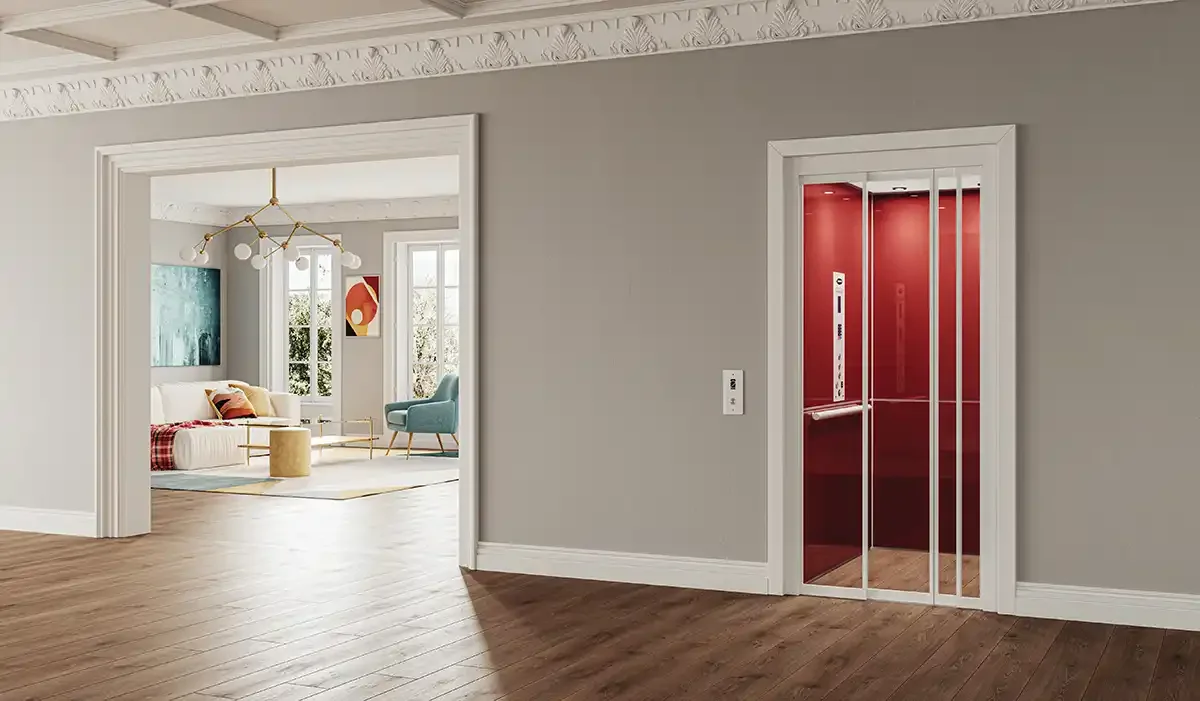 Residential elevator with red interior panels in a modern open living space