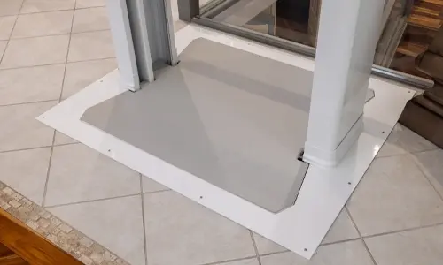 The floor plug of the Luma through the floor lift installed on tiled flooring.