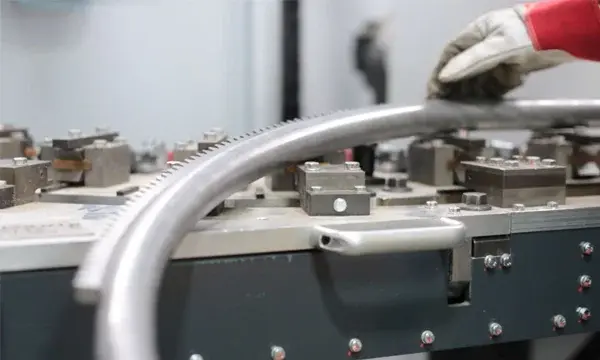 A custom curved stairlift rail during the manufacturing process.