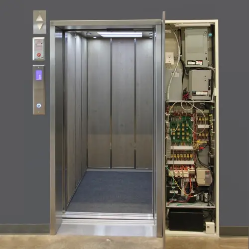 Machine room less Commercial elevator with an open panel for servicing.