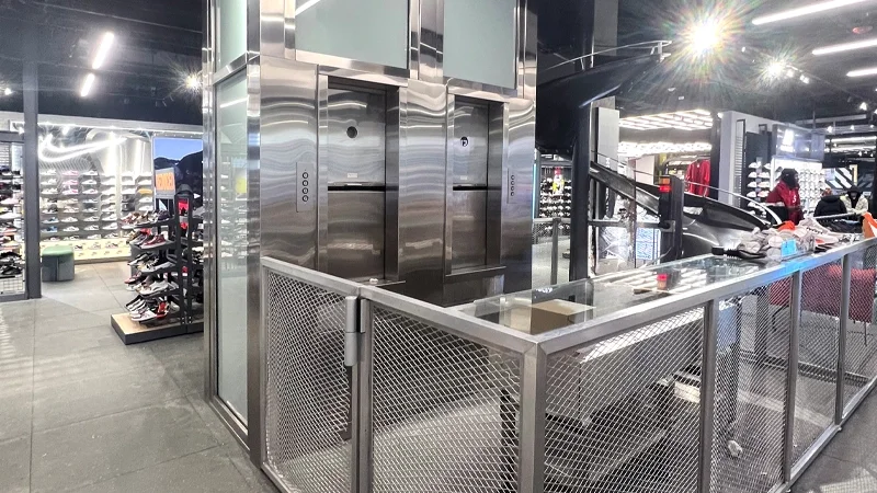 Material lifts installed side by side in a sneaker and apparel retail store.