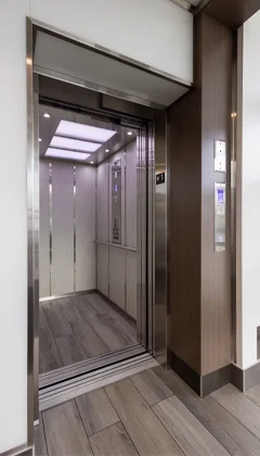 Hydraulic Elevator paired with stainless steel frame and gray laminate flooring.