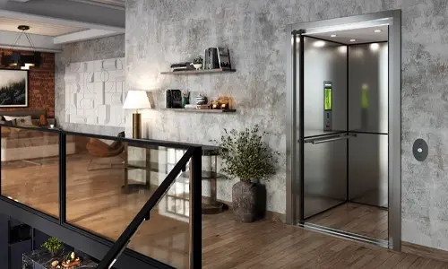 Modern residential elevator with stainless steel interior, open door, glass railing, and wood flooring installed in a contemporary loft-style home.