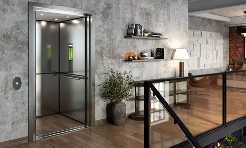 Open modern residential elevator with stainless steel interior in a contemporary loft-style home